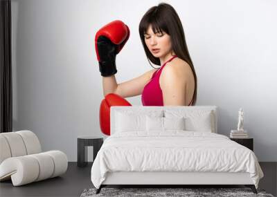 Young sport woman isolated on white background with boxing gloves Wall mural