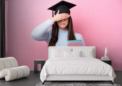 Young student Brazilian woman wearing graduated hat isolated on pink background covering eyes by hands. Do not want to see something Wall mural