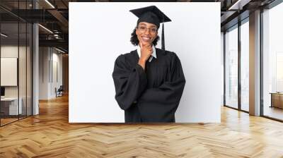 Young university graduate African American woman isolated on white background with glasses and smiling Wall mural