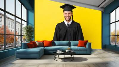 Young university graduate caucasian man isolated on yellow background with surprise facial expression Wall mural