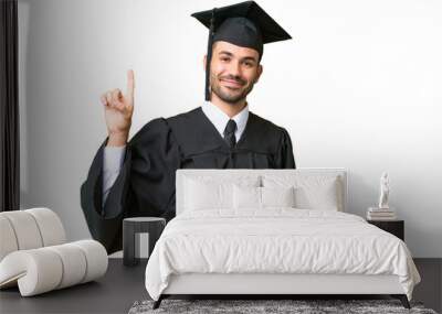 Young university graduate man over isolated background showing and lifting a finger in sign of the best Wall mural