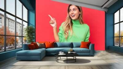 Young Uruguayan woman isolated on red background intending to realizes the solution while lifting a finger up Wall mural