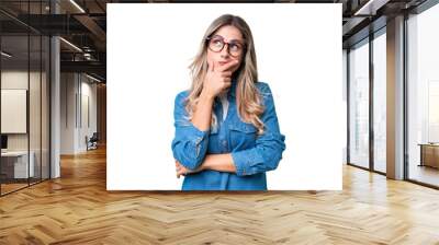 Young Uruguayan woman over isolated background having doubts and with confuse face expression Wall mural