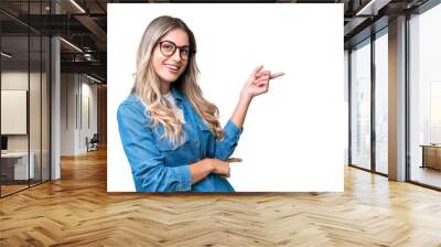 Young Uruguayan woman over isolated background pointing finger to the side Wall mural