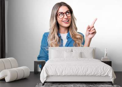 Young Uruguayan woman over isolated background pointing up a great idea Wall mural