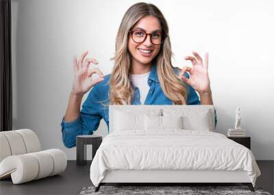 Young Uruguayan woman over isolated background showing ok sign with two hands Wall mural