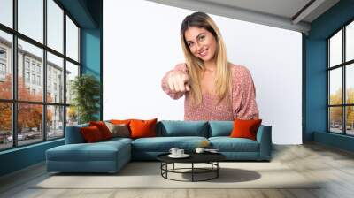 Young Uruguayan woman over isolated white background points finger at you with a confident expression Wall mural