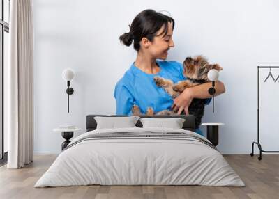 Young veterinarian woman with dog isolated on white background with happy expression Wall mural