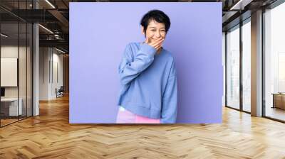 Young Vietnamese woman with short hair over isolated purple background happy and smiling covering mouth with hand Wall mural