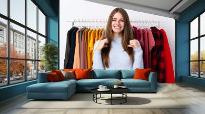 Young woman in a clothing store proud and self-satisfied Wall mural