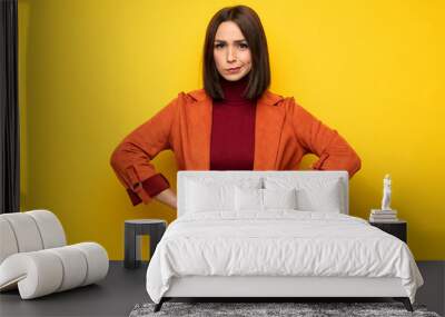 Young woman with coat angry Wall mural