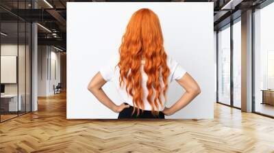 Young woman with orange hair isolated on white background in back position Wall mural