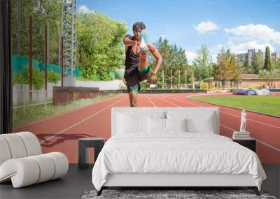 young african american man training on running track Wall mural