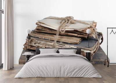 Old books and papers tied with a rope on a wooden stand, white background isolated Wall mural