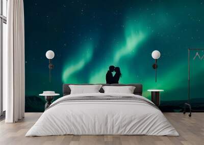 A silhouette of two lovers kissing under the aurora borealis, with an ethereal glow illuminating their faces against a backdrop of a dark blue sky and starry night Wall mural