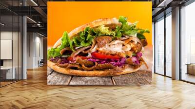 Close up of kebab sandwich on old wooden table. Wall mural