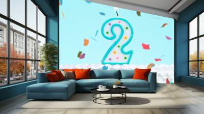 Colorful tasty birthday cake with candles shaped like the number 2. Pastel blue background. Wall mural