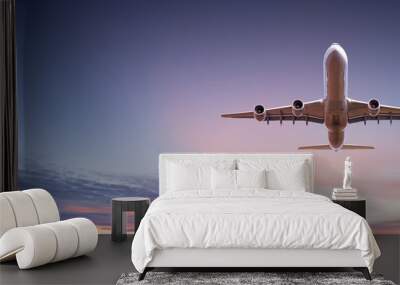 Commercial airplane jetliner flying above dramatic clouds in beautiful sunset light. Travel concept. Wall mural