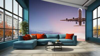 Commercial airplane jetliner flying above dramatic clouds. Wall mural