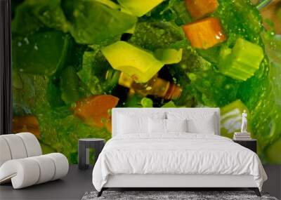 Freeze motion of mixing pieces of fruit and vegetables in blender, top shot Wall mural