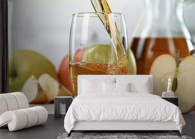 Fresh Apple Juice Being Poured in a Glass, Close-up. Wall mural