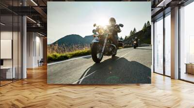 Motorcycle driver riding japanese high power cruiser in Alpine highway on famous Hochalpenstrasse, Austria. Wall mural