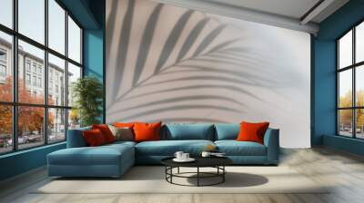 Palm leaves shadow on beige background, freeze motion Wall mural