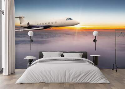 Private jet plane flying above dramatic clouds. Wall mural