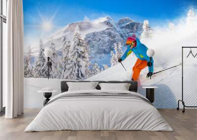 Skier skiing downhill in high mountains Wall mural