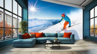 Skier skiing downhill in high mountains Wall mural