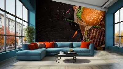 Top view of tasty burgers on wooden table. Wall mural