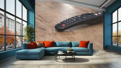 TV remote control on wooden table Wall mural