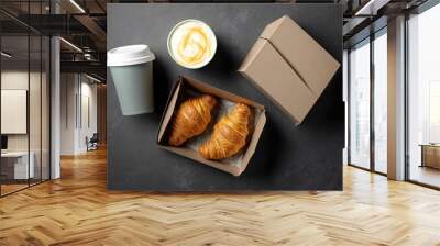 A bag of croissants and a mug of coffee with milk on the move. shipping and handling of goods. copy space at the top Generative AI Wall mural