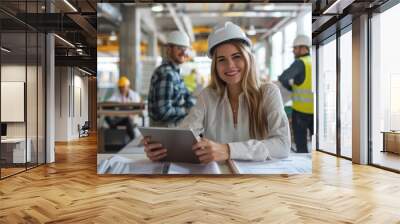 A construction and building architect, woman, and her colleagues in an office designing a project or development. Engineer, architect, or designer planning on tablet with young woman Wall mural