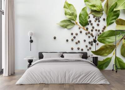 Bay leaves and black pepper peas on a white surface Wall mural