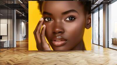 Close-up portrait of a woman with glowing skin in a yellow background, showcasing skincare and cosmetics for a luxurious dermatology or spa treatment Wall mural