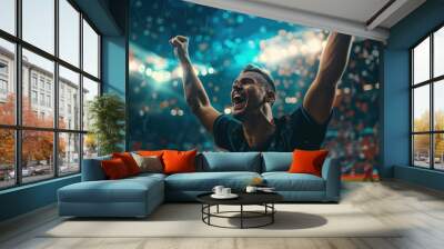 During an exciting championship game in a packed stadium under brilliant lights, a professional football player celebrates winning. Wall mural