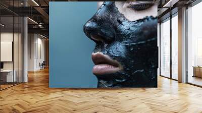 Individual using charcoal and face mask for skincare, beauty, and natural cosmetic cleansing. Portrait featuring facial collagen and mud treatment for skin health Wall mural