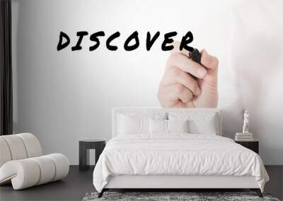 Hand of a businessman writing a word Discover with black marker in a conceptual image of discovering new ideas Wall mural