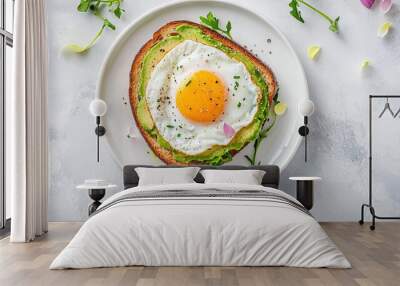 Fried egg and avocado toast on a white plate in food photography concept. Breakfast meal idea, healthy food. Wall mural