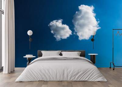 Blue sky with two white clouds closeup Wall mural