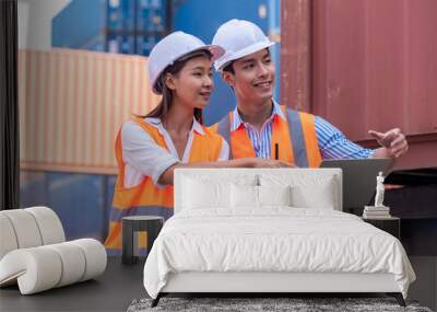 Happy man and woman Asian dock control working and talking with smile  around Shipping container stacker in commercial transport port Wall mural