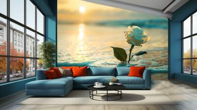 white rose in ocean waves at sunrise. A delicate white rose rests in ocean waves during a tranquil sunrise.. Wall mural