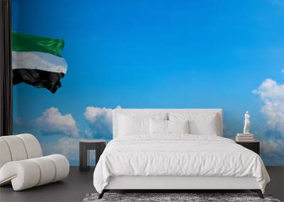 United Arab Emirates flag waving on a blue sky in beautiful clouds - Horizontal banner Wall mural