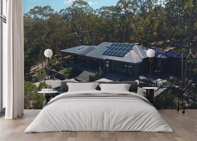 Photograph showcasing a modern and eco friendly house with solar panels on the rooftop and energy efficient appliances highlighting the concept of a sustainable living lifestyle Wall mural