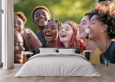 A vibrant group photo featuring a diverse group of young people smiling and laughing together, symbolizing unity and diversity on International Youth Day Wall mural