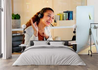 A happy modern business woman having an online meeting at her computer. A cheerful worker talking during a corporate teamwork seminar. A female accountant on a company web conference at her desk. Wall mural