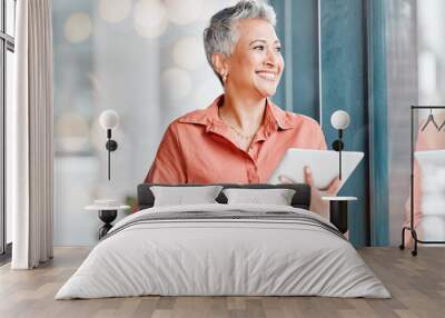 Tablet, thinking and senior business woman in office contemplating, research or internet browsing. Technology, ideas or happy elderly female with touchscreen by window for networking or web scrolling Wall mural