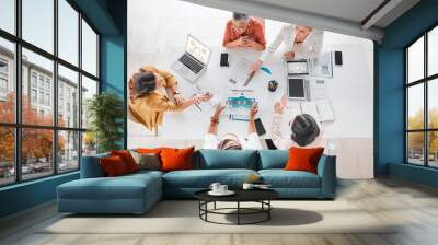 Top view, research or business people with documents in meeting for company growth, strategy review or teamwork in office. Group of startup women for SEO, schedule or working on planning KPI agenda Wall mural