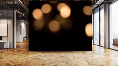 Golden bokeh light isolated on black background Wall mural